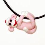 Pink Sock Monkey Pendant Swinging From All Fours..